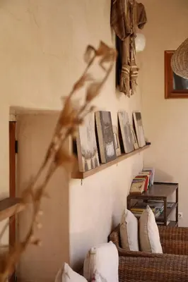 a living room with a shelf with books on the wall at Dar Nour el Houda in Marrakech