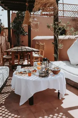 a white table with food and drinks on it at Dar Nour el Houda in Marrakech