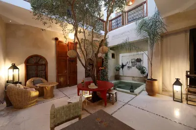 a living room with a tree in the middle of it at Dar Nour el Houda in Marrakech