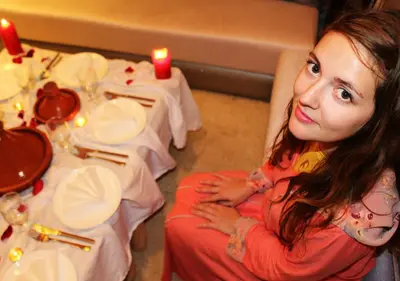 a young woman sitting at a table with candles at Hostel Dream belko in Marrakech