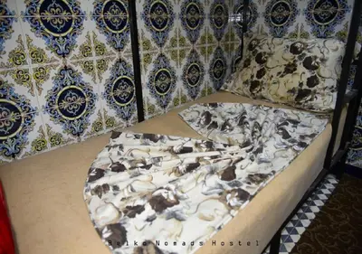 a bed with a painting of animals on it at Hostel Dream belko in Marrakech