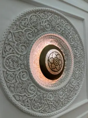 a ceiling light with a metal design on a ceiling at Riad Andalla in Marrakech