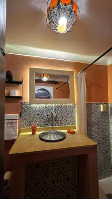 a bathroom with a sink and a mirror at Riad Andalla in Marrakech