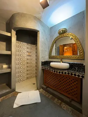 a bathroom with a sink and a mirror at Riad Andalla in Marrakech