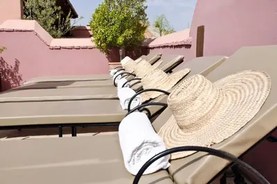 a row of chairs sitting on a balcony with a plant at Dar Rocmarra in Marrakech