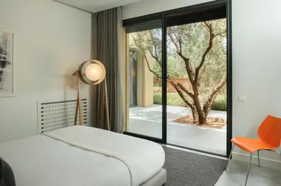 a bedroom with a bed and a large window at Villa BELYA in Marrakech