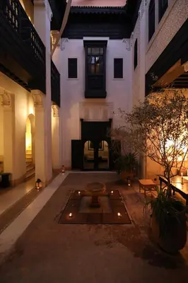 a living room with a fireplace in a building at Riad Azzouna 13 in Marrakech