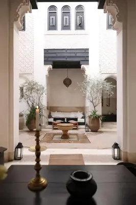 a room with a candle in the middle of a building at Riad Azzouna 13 in Marrakech