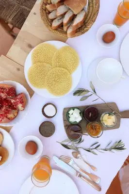 a white table with plates of food on it at Riad Azzouna 13 in Marrakech