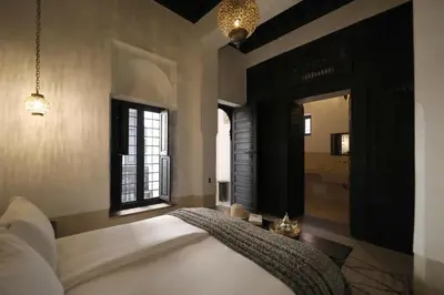 a bedroom with a bed and a window and a mirror at Riad Azzouna 13 in Marrakech