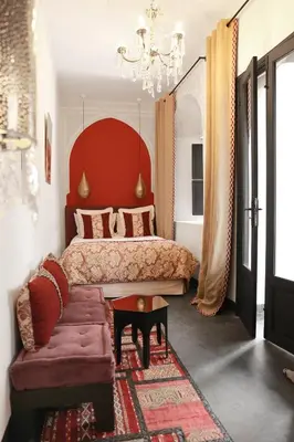 a bedroom with a large bed and a couch at Riad Dar Bahi in Marrakech