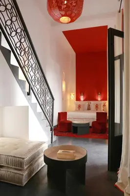 a bedroom with a bed and a stairway with a bed and a table at Riad Dar Bahi in Marrakech