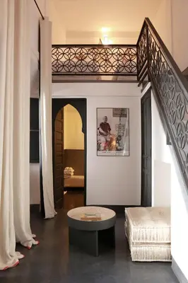 a living room with a staircase and a couch at Riad Dar Bahi in Marrakech
