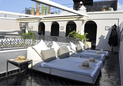 a row of beds sitting on a balcony at Riad Dar Bahi in Marrakech