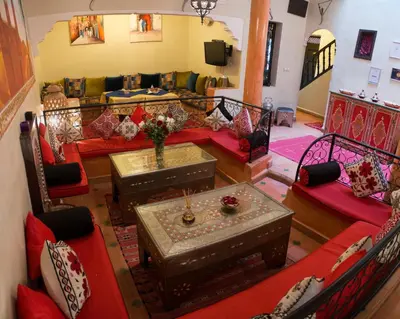 a living room with red couches and a couch at Dar Asdika in Marrakech