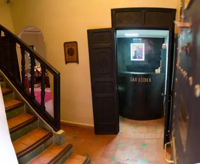 a hallway with a door that says daraja at Dar Asdika in Marrakech