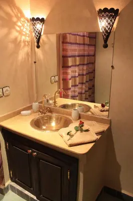 a bathroom with a sink and a mirror at Dar Asdika in Marrakech