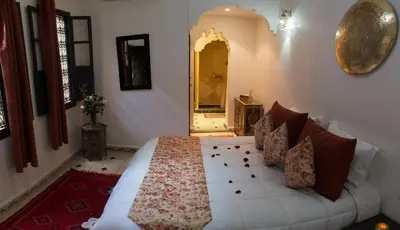 a bedroom with a white bed in a room at Dar Asdika in Marrakech