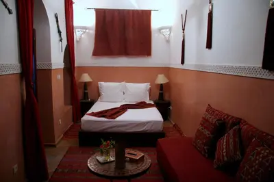 a hotel room with a bed and a couch at Riad Zen House in Marrakech