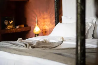 a close up of a bed in a bedroom at Riad Mur Akush in Marrakech