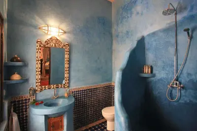 a blue bathroom with a sink and a tub at Riad Mur Akush in Marrakech