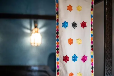 a curtain with stars on it next to a light at Riad Mur Akush in Marrakech
