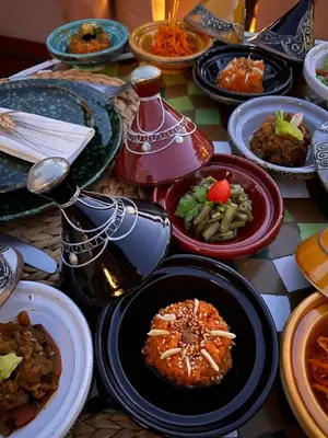 a table full of plates of food on a table at Riad El Youssoufi in Marrakech