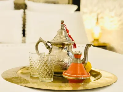 a tea kettle and a glass on a tray at Maison Chafia Boutique Hôtel & Spa in Marrakech