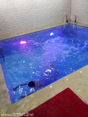 a swimming pool with a dog in the water at Silia in Marrakech
