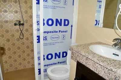 a sign in a bathroom with a toilet and a sink at Silia in Marrakech