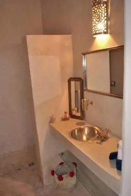 a bathroom with a sink and a mirror at Riad Essaada in Marrakech