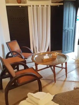 a living room with chairs and a coffee table at Riad Essaada in Marrakech
