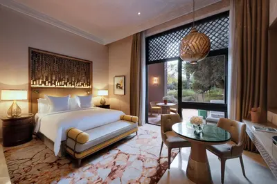 a bedroom with a bed and a large window at Four Seasons Resort Marrakech in Marrakech