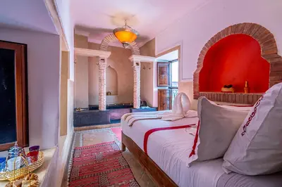 a bedroom with a bed and a couch in a room at Samira Group & Spa in Marrakech