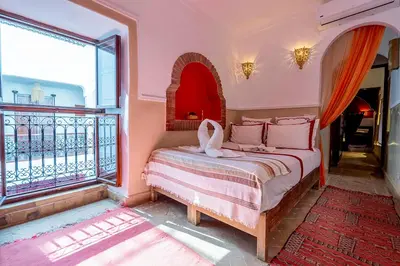 a bedroom with a bed and a large window at Samira Group & Spa in Marrakech