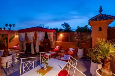 a patio with a table and chairs and a gazebo at Samira Group & Spa in Marrakech