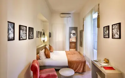 a hotel room with a bed and a chair at Hotel & Spa Riad Al Jazira in Marrakech