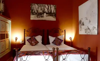 a bedroom with a bed with two pillows at Riad Noos Noos & Spa in Marrakech