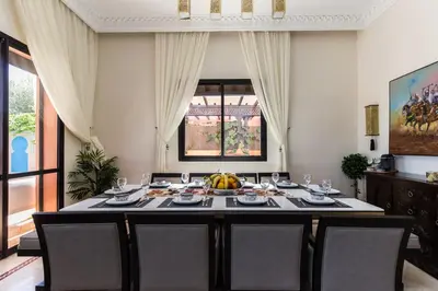 a dining room with a table with fruit on it at VILLA ILYANA in Marrakech
