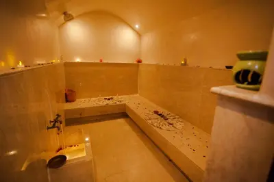a bathroom with a bath tub with a sink at Riad Melhoun & Spa in Marrakech