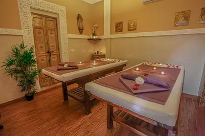 a room with two beds and a table at Riad Melhoun & Spa in Marrakech