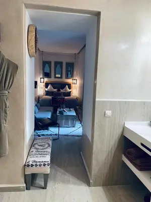 a hallway leading to a living room with a couch at Riad Dar 73 in Marrakech