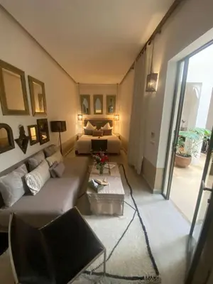 a living room with a couch and a bed at Riad Dar 73 in Marrakech