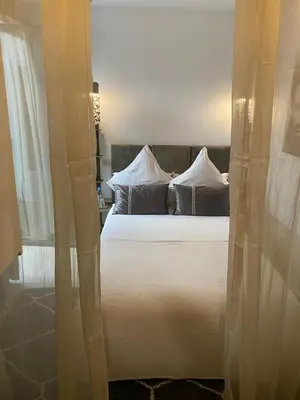 a large white bed with pillows in a bedroom at Riad Dar 73 in Marrakech