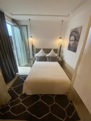 a bedroom with a large white bed and a window at Riad Dar 73 in Marrakech