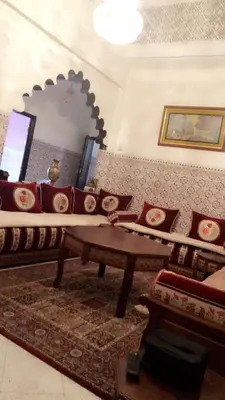 a living room with a couch and a mirror at Dar Soraya al Madina Marrakech in Marrakech