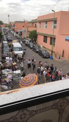 a group of people standing around in a parking lot at Dar Soraya al Madina Marrakech in Marrakech