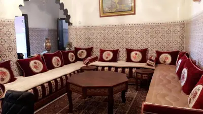 a living room with a couch and red pillows at Dar Soraya al Madina Marrakech in Marrakech