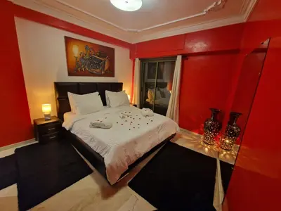 a bedroom with red walls and a large bed at Elegant Gueliz Retreat near Majorelle in Marrakech