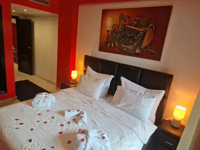 a bedroom with a bed with white sheets and pillows at Elegant Gueliz Retreat near Majorelle in Marrakech